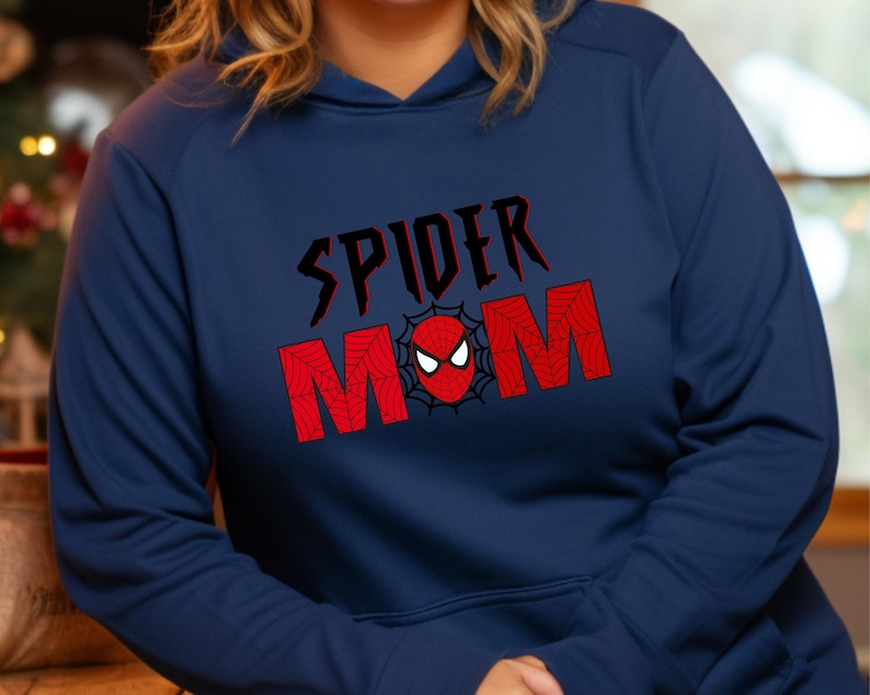 May include: Navy blue hoodie with a red and black graphic that says "Spider Mom" with a spider web design and a red spider head in the center.