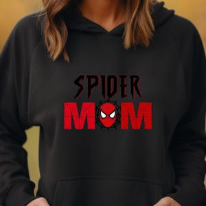 May include: Black hooded sweatshirt with the text "SPIDER MOM" in red and black with a red spider-man face in the middle of the word "MOM".