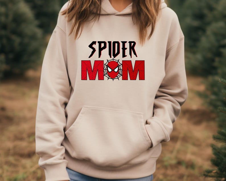 May include: A beige hoodie with a red and black graphic that says "SPIDER MOM" with a spider web and spider face in the middle.