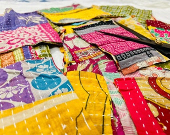 May include: A collection of colorful fabric scraps sewn together in a patchwork pattern. The fabric is a mix of floral prints, geometric patterns, and solid colors. The scraps are arranged in a random order, creating a unique and eye-catching design.