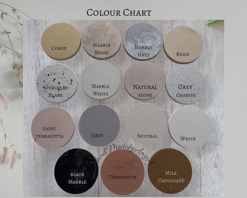 May include: A color chart featuring twelve circular samples in various shades, including beige, gray, and terracotta. Each sample is labeled with its color name, such as "Marble Beige" and "Milk Chocolate". The text "COLOUR CHART" is at the top.