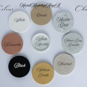 May include: Color chart with 10 round samples of different colors, including white, black, terracotta, yellow oxide, marble grey, silver grey granite, white marble, coade, and neutral. The chart is labeled "Colour" and "Chart" at the top.