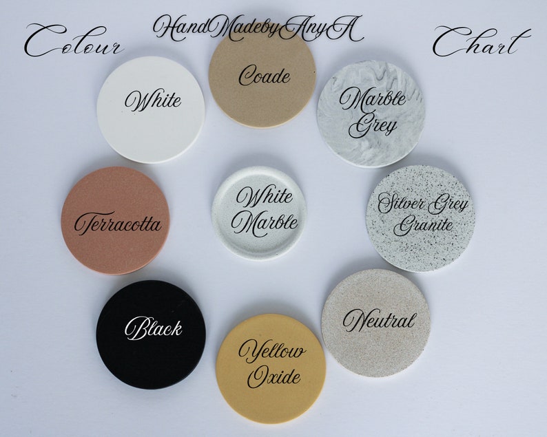 May include: Color chart with 10 round samples of different colors, including white, black, terracotta, yellow oxide, marble grey, silver grey granite, white marble, coade, and neutral. The chart is labeled "Colour" and "Chart" at the top.