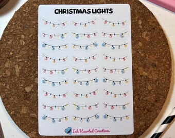 Puede incluir: Una hoja de pegatinas con 20 imágenes de luces de Navidad. Cada imagen presenta una cadena de luces con bombillas rojas, azules y amarillas. La hoja es blanca con texto negro que dice "CHRISTMAS LIGHTS" y "Ink Hearted Creations".