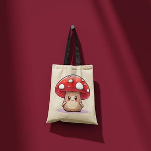 May include: A beige tote bag with black straps features a cartoon mushroom with a red cap and white spots. The mushroom has a smiling face and is on a light purple background.