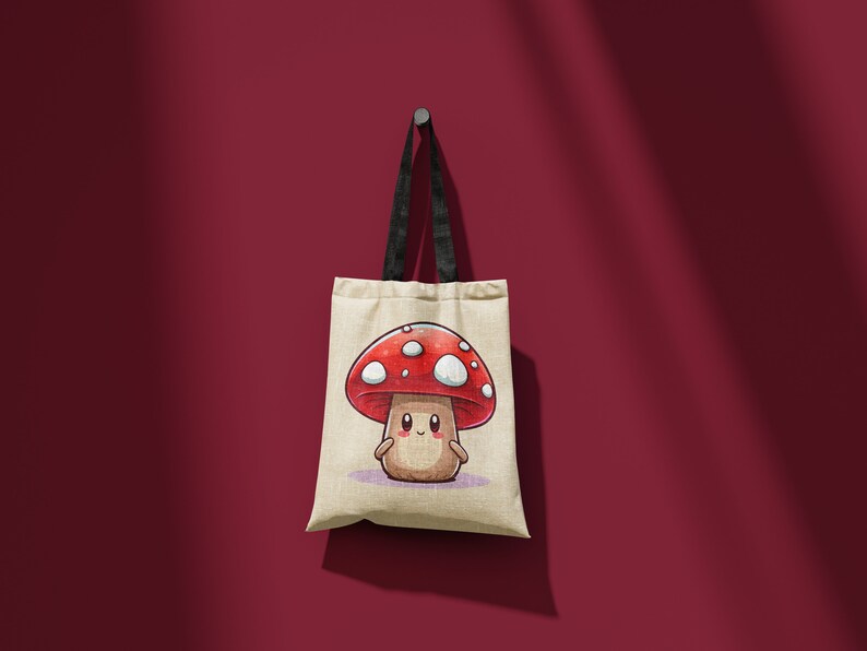 May include: A beige tote bag with black straps features a cartoon mushroom with a red cap and white spots. The mushroom has a smiling face and is on a light purple background.