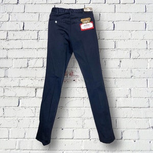May include: A pair of dark blue pants with a Levi's tag attached. The pants have a straight leg and a classic fit.