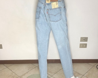 May include: Light blue denim jeans with a red tab and a paper tag that says "501" and "W32 L32".