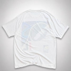 May include: White t-shirt with a colorful graphic design on the back. The graphic features a geometric pattern with blue, red, and yellow accents. The shirt is made of a soft, lightweight material, perfect for casual wear.