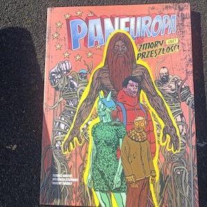 May include: A comic book cover with the title "PANEUROPA" in blue and white, featuring a large, brown, bearded figure and several other stylized characters. The background is red with star shapes.