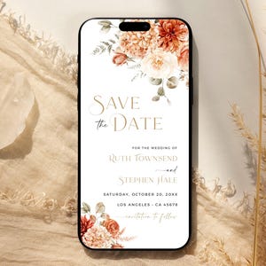 May include: A smartphone screen showing a wedding "Save the Date" invitation. The design incorporates orange, peach, and white floral elements. Text includes names, date, and location details for the wedding.