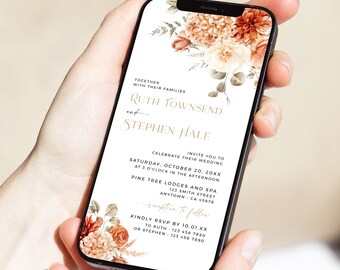 May include: A smartphone displays a wedding invitation with floral accents in shades of orange, peach, and cream. The invitation text includes the names Ruth Townsend and Stephen Hale, along with event details.