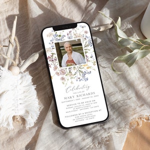 May include: A floral phone screen mockup with a photo of a woman in a floral wreath. The text reads "Celebrating the life of Mary Richards September 1, 19XX - August 22, 20XX Service to be held on Sunday, August 25, 20XX at 3PM St. Mary's Church Main Street Anytown, CA 45678 Followed by a reception at Pine Grove Hotel 96 Tanner's Park Road Anytown, CA 45678"