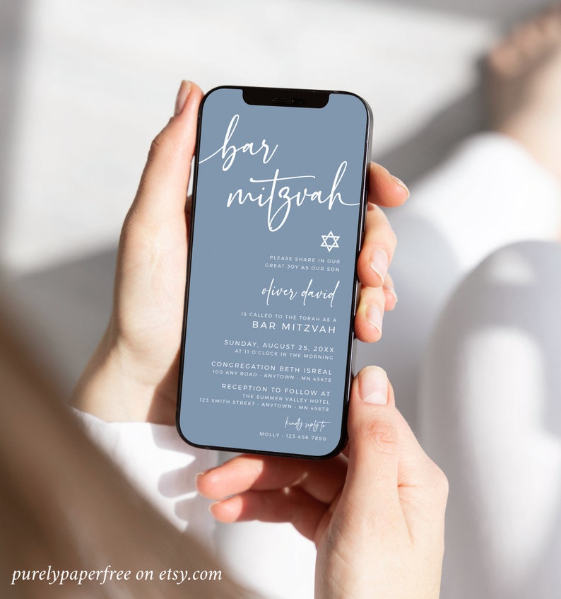 May include: A smartphone displays a Bar Mitzvah invitation on a blue background. The invitation includes the text "bar mitzvah", the name "Oliver David", and event details. The phone is held by a person.