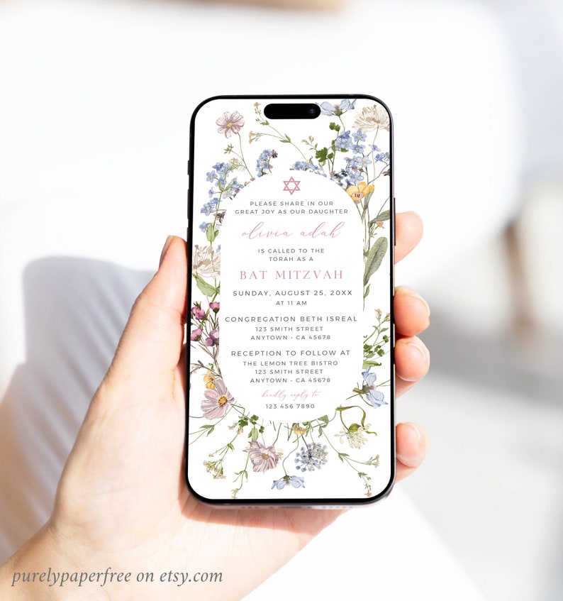 May include: A floral phone screen mockup with a Bat Mitzvah invitation for Olivia Adah. The invitation includes the date, time, and location of the event. The text reads: "Please share in our great joy as our daughter Olivia Adah is called to the Torah as a Bat Mitzvah. Sunday, August 25, 20XX at 11 AM. Congregation Beth Isreal 123 Smith Street Anytown, CA 45678. Reception to follow at The Lemon Tree Bistro 123 Smith Street Anytown, CA 45678. RSVP to 123 456 7890."