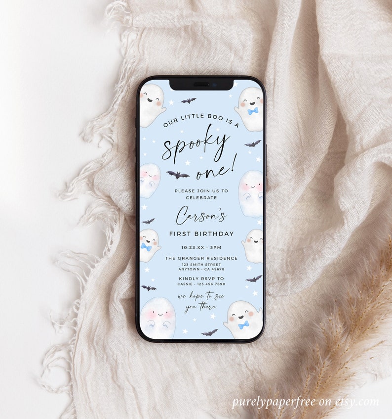 Electronic spooky one first birthday evite for a phone that has cute ghosts, a soft blue background and a modern font. Easy to edit and send out to family and friends via text.