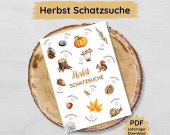May include: A printable checklist for a fall scavenger hunt. The checklist includes images of items to find, such as a pinecone, acorn, mushroom, and a spider web. The text on the checklist says "Herbst Schatzsuche" which translates to "Autumn Treasure Hunt".