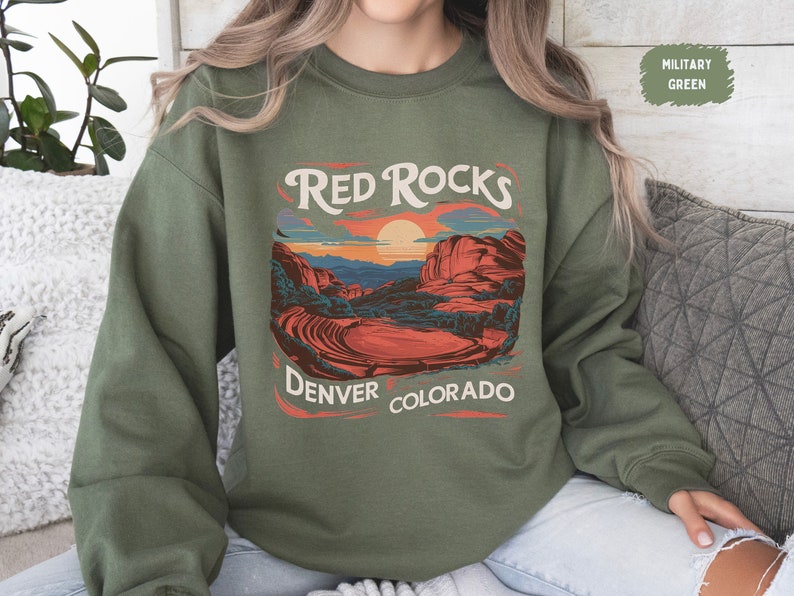 May include: A green sweatshirt with a graphic print of a sunset over red rocks with the text "Red Rocks Denver Colorado".