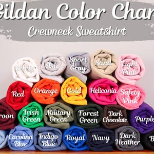 May include: Gildan Color Chart for Crewneck Sweatshirts. The chart shows a variety of colors, including white, ash, sport gray, sand, light pink, red, orange, gold, heliconia, safety pink, maroon, Irish green, military green, forest green, dark chocolate, purple, light blue, Carolina blue, indigo blue, royal blue, navy, dark heather, and black.
