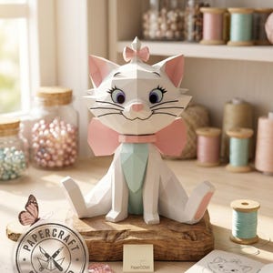 May include: A low-poly papercraft figure of a white kitten with large blue eyes, a pink bow on its head, and a pink collar with a large bow. The kitten has a light blue chest panel and pink inner ears. A circular logo reads PAPERCRAFT DOWNLOAD.
