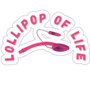 Könnte beinhalten: Rosafarbener Aufkleber mit dem Text "Lollipop of Life" in einem Bogen. Ein rosa Kopfhörer ist in der Mitte des Aufklebers abgebildet.