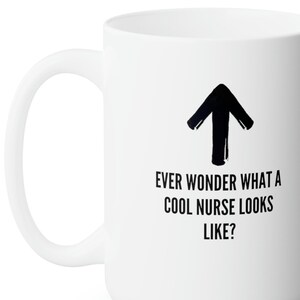 May include: White ceramic mug with a black arrow pointing upwards and the text "Ever wonder what a cool nurse looks like?"