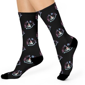 May include: A pair of black socks with a repeating pattern of a pink and blue graphic that says "Wrong Girl" in a retro font.