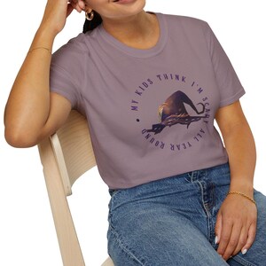 May include: A purple t-shirt with the text 