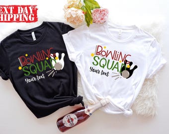 May include: A black t-shirt and a white t-shirt, each featuring a graphic of a bowling pin and ball with the text "BOWLING SQUAD" in red and green, and the placeholder text "Your text" in black script below the graphic.