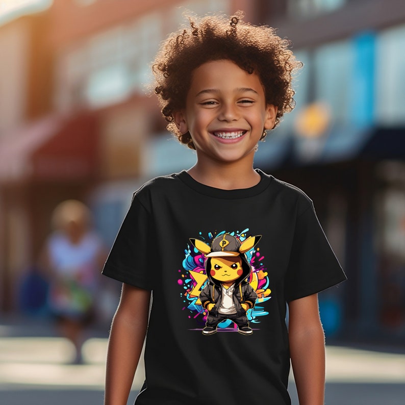 May include: A black t-shirt with a graphic of a yellow Pikachu wearing a black hoodie and a baseball cap. The Pikachu is standing in front of a colorful background with blue, pink, and yellow paint splatters.