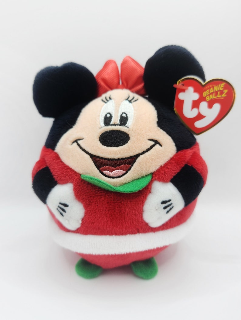 Puede incluir: Juguete de peluche rojo y blanco de Minnie Mouse con un traje de Pap&aacute; Noel rojo y blanco con ribete verde. El juguete tiene una etiqueta Ty Beanie Ballz unida a su oreja.