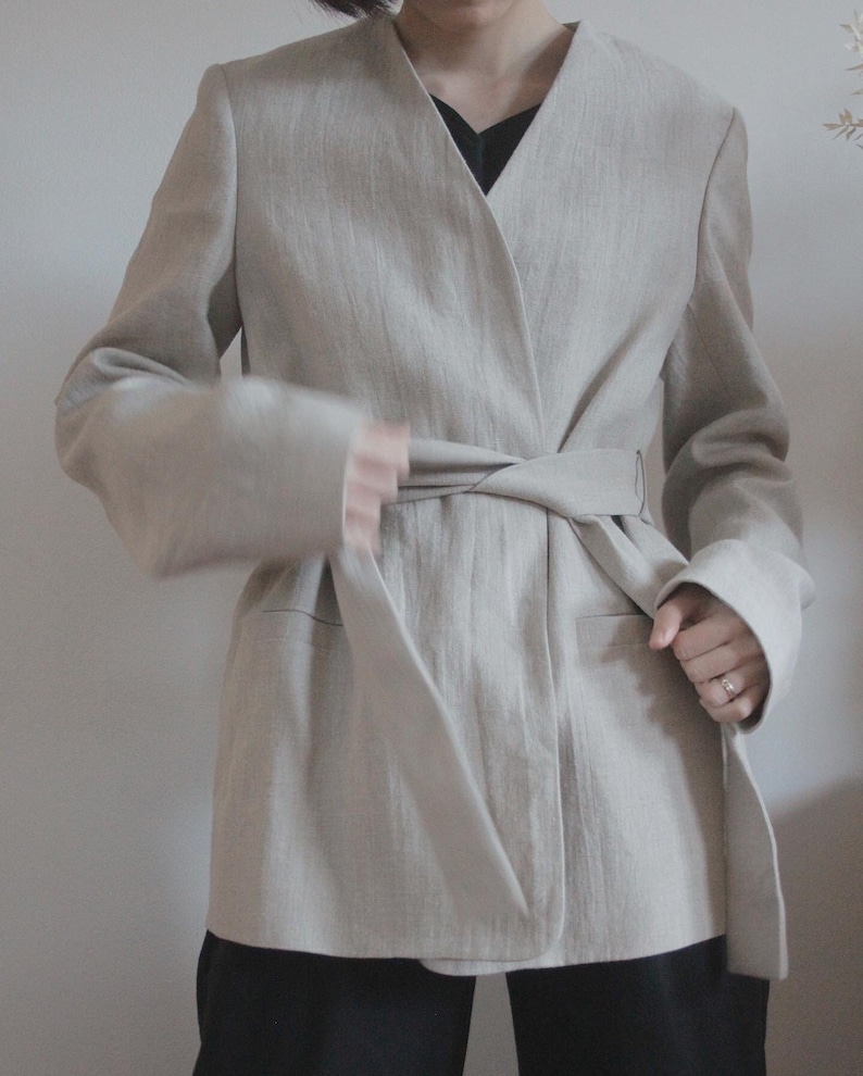 preloved COS linen blazer with belt in beige. Minimal design from COS. This blazer is made from pure linen with a belt to make it both work and weekend friendly. It will elevate all your spring outfits.