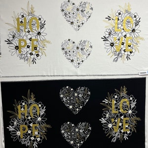 May include: Two fabric panels with a black and white floral design. The top panel has a white background with black floral designs and gold lettering that says "HOPE" and "LOVE". The bottom panel has a black background with white floral designs and gold lettering that says "HOPE" and "LOVE".