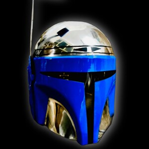 May include: A blue and silver helmet with a visor and a small antenna on top. The helmet has a black stripe down the center.