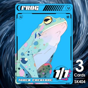 May include: A trading card featuring a stylized illustration of a frog. The card has a blue background with the word "FROG" at the top. The frog is light green with colorful spots. The card also includes the text "TOKEN CREATURE" and "1/1".