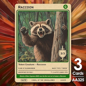 May include: A trading card featuring a raccoon illustration. The raccoon is brown and white, with an open mouth and raised paws, set against a forest backdrop. The card includes text: "RACCOON", "Token Creature", and "3/3".