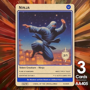 May include: A blue and white trading card with a ninja illustration. The card is titled "Ninja" and has a 2/1 power and toughness rating. The card is from the "Plane of Kamigawa" set and is a "Token Creature - Ninja". The card is from the "Adventure Edition II" set and is a "Magic Type 4 "Blue"". The card is from "Alfie's Games 1978". The card is part of the "Cabal of the Unhallowed" set and has the number "AA405".
