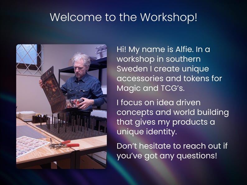 May include: A man in a workshop holds a print, with the text "Welcome to the Workshop!" and a description of creating accessories and tokens for Magic and TCG's. A table with tools and supplies is in the foreground.