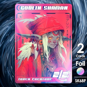 Op de afbeelding: Een holografische trading card met een goblin-sjaman in rood en witte kleding. De kaart heeft de titel "Goblin Shaman" en heeft de tekst "Token Creature" onderaan. De kaart is foil en heeft een holografisch effect.