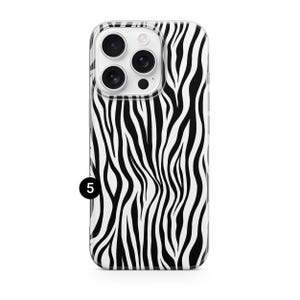 May include: A clear phone case with a black and white zebra stripe pattern. The case has a camera cutout and a small black number 5 in the lower left corner.