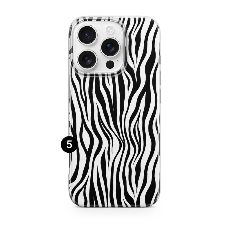 May include: A clear phone case with a black and white zebra stripe pattern. The case has a camera cutout and a small black number 5 in the lower left corner.