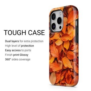 May include: A phone case with a fall leaves design. The case features a glossy finish and 360-degree side coverage. The text "TOUGH CASE" is displayed on the left side of the case. The case offers dual layers for extra protection and easy access to ports.