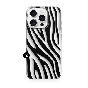 May include: A smartphone case with a black and white zebra stripe pattern. The case has a clear border and a camera cutout. The number 2 is printed in black on the lower left corner of the case.