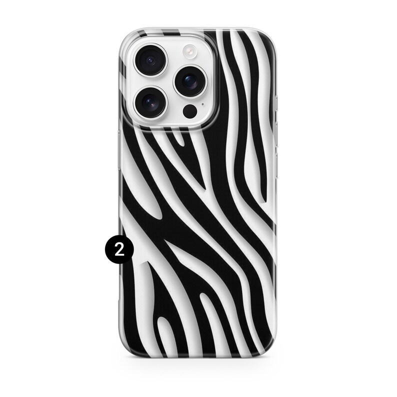 May include: A smartphone case with a black and white zebra stripe pattern. The case has a clear border and a camera cutout. The number 2 is printed in black on the lower left corner of the case.
