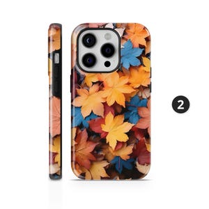 May include: A phone case featuring a vibrant autumn leaf design. The case displays a pattern of colorful leaves in shades of yellow, orange, red, and blue. The side view of the case is also visible, showing a continuation of the leaf pattern.