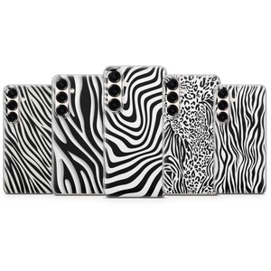 May include: A collection of five phone cases with animal print designs. The cases feature zebra stripes and leopard spots in black and white. Each case has a camera cutout and button placements.