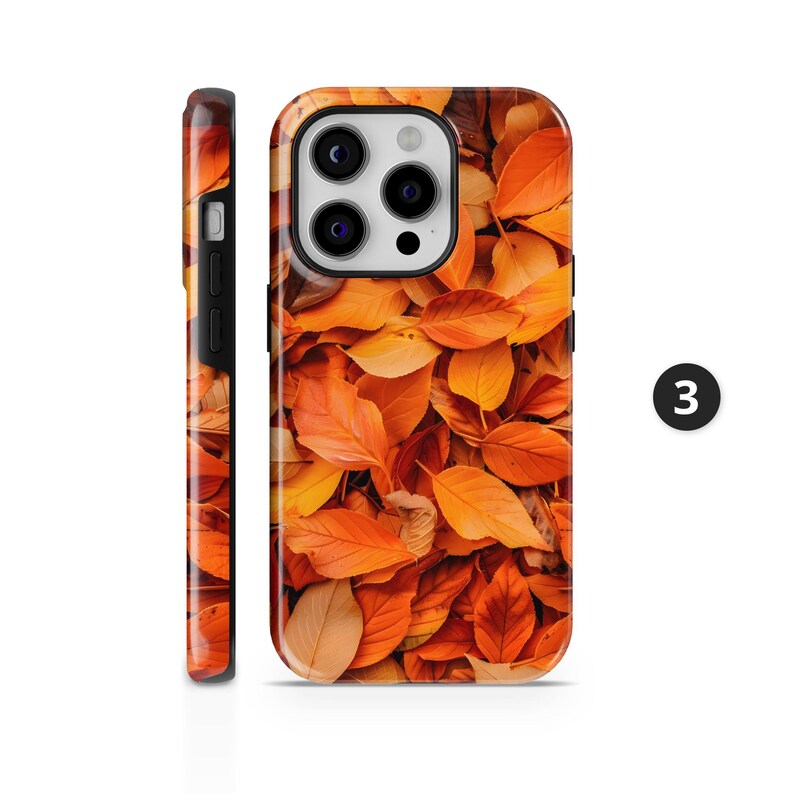 May include: A phone case featuring a vibrant autumn leaf design. The case displays a close-up of orange, yellow, and brown leaves, creating a warm, seasonal aesthetic. The number 3 is visible on the side.