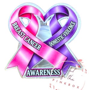 May include: A heart-shaped awareness badge featuring a pink ribbon with the text BREAST CANCER and a purple ribbon with the text DOMESTIC VIOLENCE. The word AWARENESS is printed in black on a light blue banner at the bottom of the ribbons.