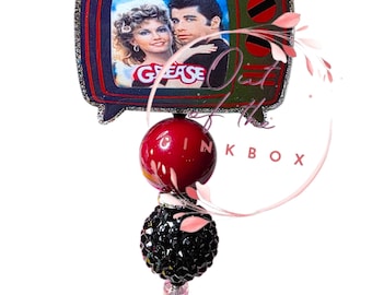 Grease- Relive the magic of Rydell High with this Grease retro TV badge reel!