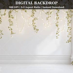 May include: A digital backdrop featuring a white wall with decorative columns and trim. Overhead, a string of lights and hanging greenery adds a touch of elegance. The text "DIGITAL BACKDROP" and other details are visible at the top.